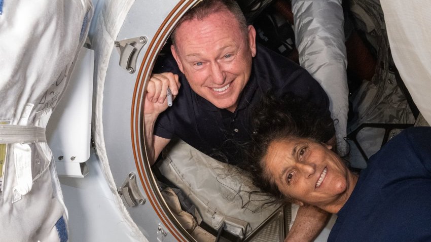 NASA astronauts Butch Wilmore, left, and Suni Williams pose inside the hatch connecting Boeing’s Starliner to the International Space Station on