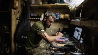 A soldier fixes a drone underground in a Ukrainian military position, and former Russian military position, in Ukrainian-controlled territory on August 18th 2024, in Kursk, Russia. Ukrainian forces operating in Russia’s Kursk Region have destroyed a second key bridge, the commander of the Ukrainian Air Force said, as they attempt to push further into Russia. 