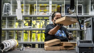 A worker prepares packages at an Amazon same-day delivery fulfillment center on Prime Day in the Bronx borough of New York, US, on Tuesday, July 16, 2024. Amazon.com Inc.’s Prime Day sales rose about 13% in the first six hours of the event compared with the same period last year, according to Momentum Commerce, which manages 50 brands in a variety of product categories. Photographer: Stephanie Keith/Bloomberg via Getty Images