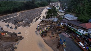 Indian army soldiers set up a prefabricated bridge for across the river rescue operations