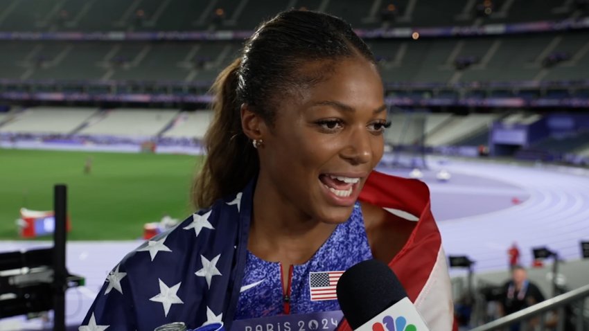 GABBY THOMAS HOLDING AN AMERICAN FLAG