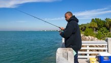 Miami-Dade resident Byron fishes while out in the cool weather at Bill Baggs Cape Florida State Park on Thursday, Dec. 10, 2020, in Key Biscayne, Florida. (David Santiago/Miami Herald/Tribune News Service via Getty Images)