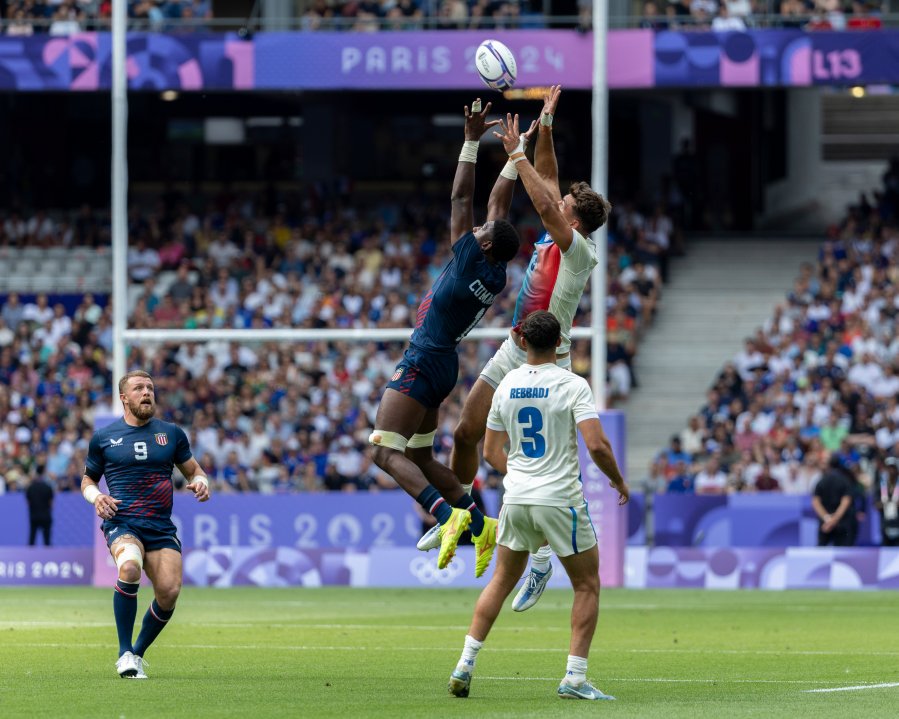 Aaron Cummings of the USA Men's National Team and Antoine Zeghdar of the France Men's National Team leap for the ball