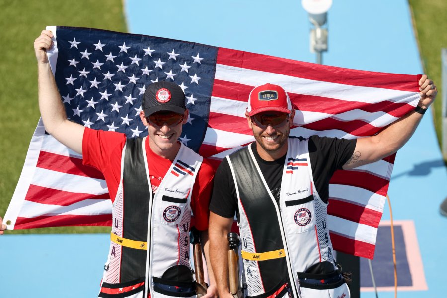 Gold medallist Vincent Hancock and silver medallist Conner Lynn Prince (L) pose with the US flag