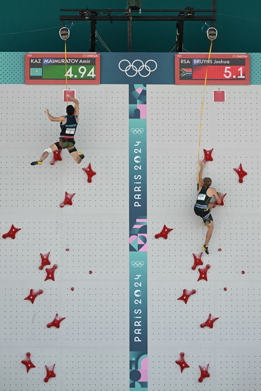 Kazakhstan's Amir Maimuratov competes against South Africa's Joshua Bruyns in the men's sport climbing speed preliminary round's elimination heats during the Paris 2024 Olympic Games at Le Bourget Sport Climbing Venue in Le Bourget on August 6, 2024