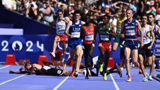 Spain’s Thierry Ndikumwenayo (2L), Britain’s George Mills (L) and Refugee Team’s Dominic Lokinyomo Lobalu (back) fall as other athletes compete in the men’s 5000m heat of the athletics event at the Paris 2024 Olympic Games at Stade de France in Saint-Denis, north of Paris, on August 7, 2024. (Photo by Jewel SAMAD / AFP) (Photo by JEWEL SAMAD/AFP via Getty Images)