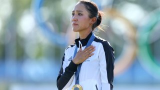 PARIS, FRANCE – AUGUST 10: Gold medalist, Lydia Ko of Team New Zealand reacts on the podium during her national anthem in the Women’s Individual Stroke Play Medal Ceremony on day fifteen of the Olympic Games Paris 2024 at Le Golf National on August 10, 2024 in Paris, France. (Photo by Andrew Redington/Getty Images)