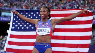 PARIS, FRANCE – AUGUST 10: Masai Russell of Team United States celebrates winning the Gold medal in the Women’s 100m Hurdles Final on day fifteen of the Olympic Games Paris 2024 at Stade de France on August 10, 2024 in Paris, France. (Photo by Patrick Smith/Getty Images)