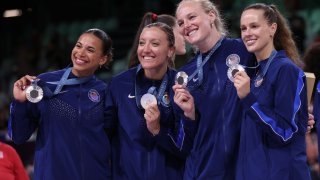 PARIS, FRANCE – AUGUST 11: Silver medalists Avery Skinner, Jordan Larson, Kathryn Plummer and Kelsey Robinson of Team United States pose with their medals after the Women’s Gold Medal match between Team United States and Team Italy on day sixteen of the Olympic Games Paris 2024 at Paris Arena on August 11, 2024 in Paris, France. (Photo by Ezra Shaw/Getty Images)