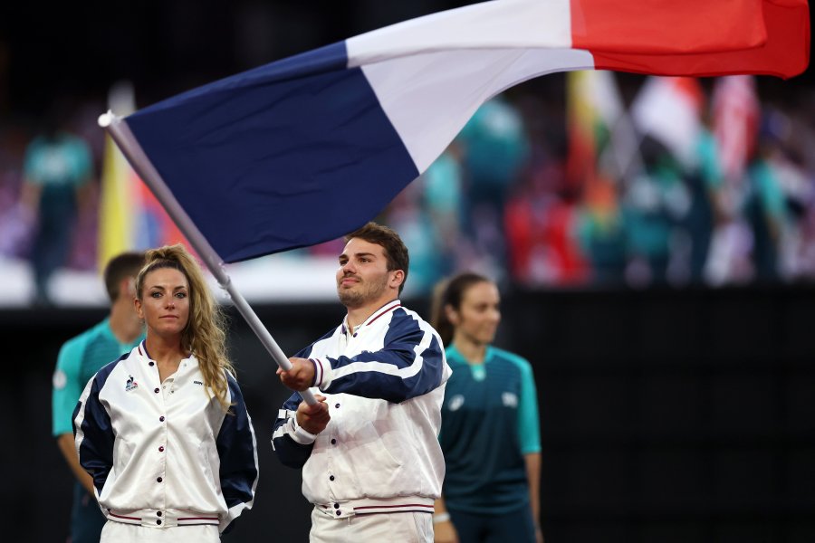 Flagbearers Antoine Dupont and Pauline Ferrand Prevot of Team France