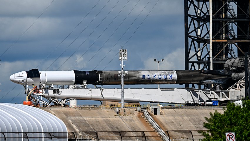 A SpaceX Falcon 9 rocket with the Crew Dragon Resilience capsule sits on Launch Complex 39A at Kennedy Space Center ahead of the Polaris Dawn Mission in Cape Canaveral, Florida, August 27, 2024. The mission was set to lift off early August 26 from NASA’s Kennedy Space Center, but is now targeting early August 28 after a late technical hitch. “Teams are taking a closer look at a ground-side helium leak on the Quick Disconnect umbilical,” SpaceX wrote on X, formerly Twitter. (Photo by CHANDAN KHANNA / AFP) (Photo by CHANDAN KHANNA/AFP via Getty Images)