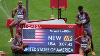 Vernon Norwood (USA), Shamier Little (USA), Bryce Deadmon (USA) and Kaylyn Brown (USA) pose with their world record time after the 4x400m relay mixed round 1 during the Paris 2024 Olympic Summer Games at Stade de France. 