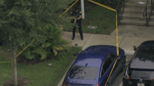 What appears to be a handgun is seen on a sidewalk after a police shooting in Miami that left a man critically injured.