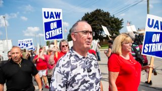 UAW president Shawn Fain and members and workers at the Mopar Parts Center Line, a Stellantis Parts Distribution Center in Center Line, Michigan, picket outside the facility after walking off their jobs at noon on September 22, 2023.