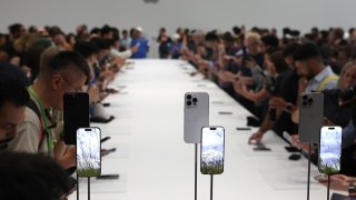 Attendees inspect the new iPhone 16 Pro and 16 Pro Max during an Apple special event at Apple headquarters on September 09, 2024 in Cupertino, California. 