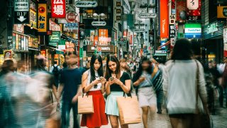 Japanese girls hanging out on Shibuya streets of Tokyo, Japan.