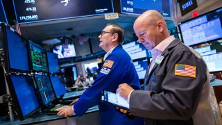 Traders work on the floor of the New York Stock Exchange.