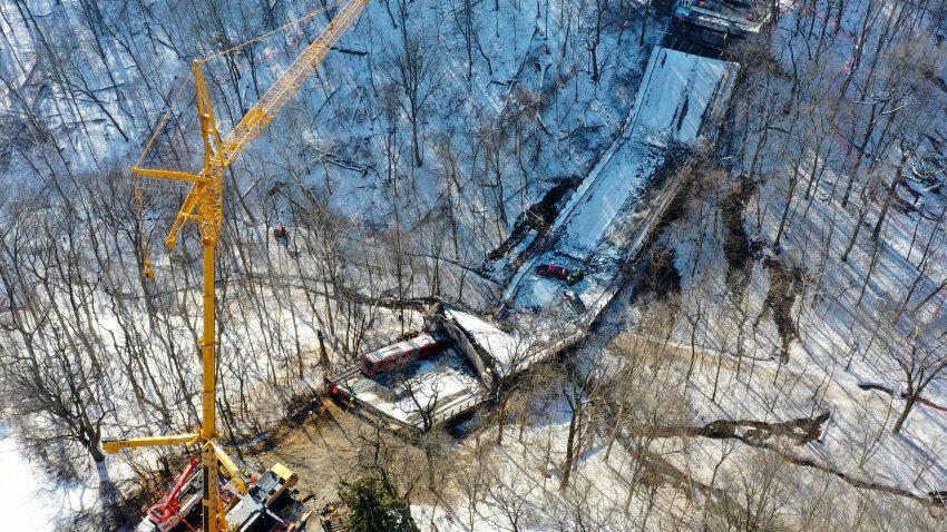 FILE – A crane is in place as part of clean up efforts at the Fern Hollow Bridge in Pittsburgh that collapsed, Jan. 28, 2022.