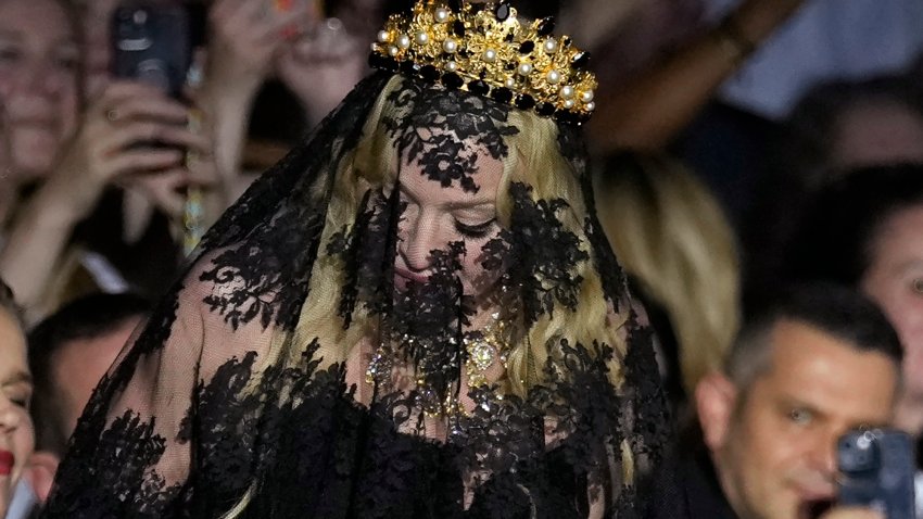 Madonna stands at the end of the Dolce & Gabbana Spring Summer 2025 fashion show