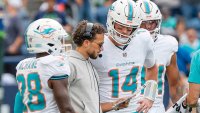 Miami Dolphins head coach Mike McDaniel speaks with quarterback Tim Boyle (14) during a timeout in the second half against the Seattle Seahawks at Lumen Field in Seattle on Sunday, Sept. 22, 2024. (Al Diaz/Miami Herald/Tribune News Service via Getty Images)