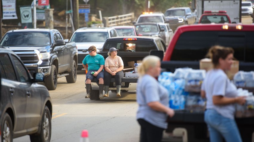 OLD FORT, NORTH CAROLINA – SEPTEMBER 30: Residents ride down Catawba Avenue as volunteers distribute supplies at the Town Hall in the aftermath of Hurricane Helene on September 30, 2024 in Old Fort, North Carolina. At least 100 people have been killed across the southeastern U.S., according to published reports. Millions are without power due to the storm, which made landfall as a Category 4 hurricane on Thursday. The White House has approved disaster declarations in North Carolina, Florida, South Carolina, Tennessee, Georgia, Virginia and Alabama, freeing up federal emergency management money and resources for those states. (Photo by Melissa Sue Gerrits/Getty Images)