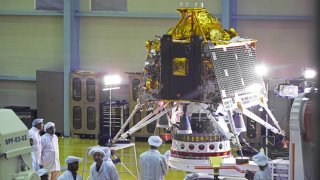 Scientists and employees view the Chandrayaan-2 spacecraft Lander module at the Indian Space Research Organization Satellite Integration and Test Establishment (ISITE) at the ISRO headquarters in Bengaluru, India, on Tuesday, June 12, 2019.