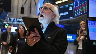 Traders work on the floor of the New York Stock Exchange.