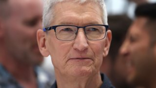 Apple CEO Tim Cook inspects the new iPhone 16 during an Apple special event at Apple headquarters on September 09, 2024 in Cupertino, California. 