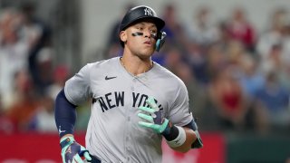 Aaron Judge #99 of the New York Yankees runs down the first base line during the eighth inning against the Texas Rangers at Globe Life Field on September 03, 2024 in Arlington, Texas. 