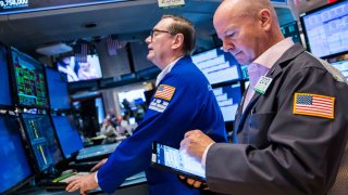 Traders work on the floor of the New York Stock Exchange.