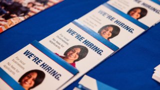 “We’re Hiring” flyers displayed at the Albany Job Fair in Latham, New York, US, on Wednesday, Oct. 2, 2024. 