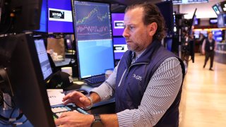 Traders work on the floor of the New York Stock Exchange during morning trading in New York City. 