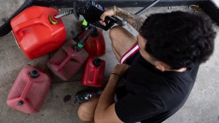 A man fills up reserve gas containers, as Hurricane Milton approaches, in Tampa, Florida October 8, 2024. 