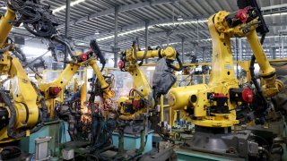 Robots manufacture auto parts at a factory in Ningde, China, on Oct. 17, 2024.