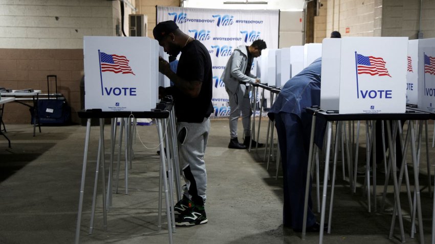 Voters fill out their ballots for the presidential election during early voting ahead of the polls closing November 5 at the Detroit Elections Office in Detroit, Michigan, U.S. October 28, 2024. 
