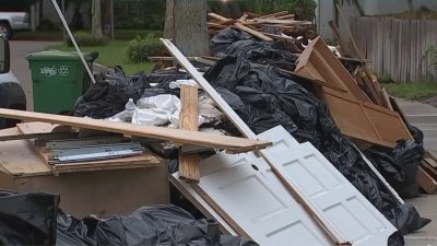 Debris piles from Helene sit outside Tampa homes as Hurricane Milton approaches