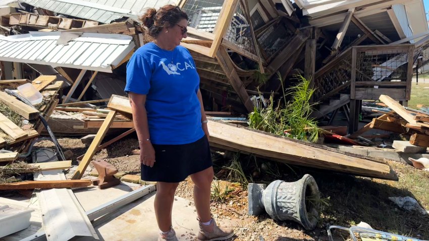 Laurie Lilliott stands amid the wreckage of her destroyed home in Dekle Beach in rural Taylor County, Fla., Friday, Sept. 27, 2024, in the aftermath of Hurricane Helene.