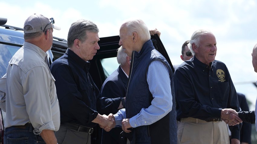 President Joe Biden shakes hands with Gov. Roy Cooper, D-N.C., with Gov. Henry McMaster, R-S.C., standing right, as he arrives at Greenville-Spartanburg International Airport in Greer, S.C., Wednesday, Oct. 2, 2024, to survey damage from Hurricane Helene.