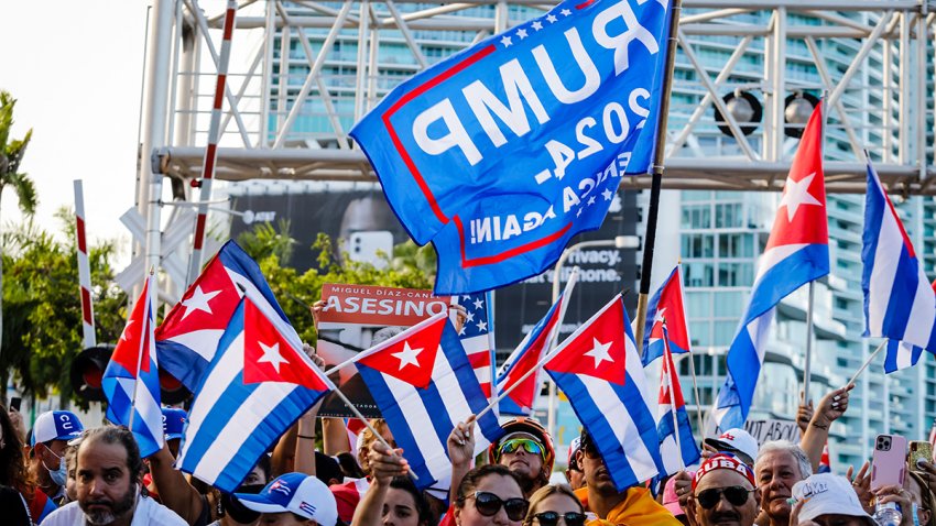 A Trump 2024 flag is seen as people wave Cuban and US flags during a Freedom Rally showing support for Cubans demonstrating against their government, at Freedom Tower in Miami, on July 17, 2021. – Cuba’s President Miguel Diaz-Canel on July 17, denounced what he said was a false narrative over unrest on the Caribbean island, as the Communist regime vigorously pushed back against suggestions of historically widespread discontent. (Photo by Eva Marie UZCATEGUI / AFP) (Photo by EVA MARIE UZCATEGUI/AFP via Getty Images)