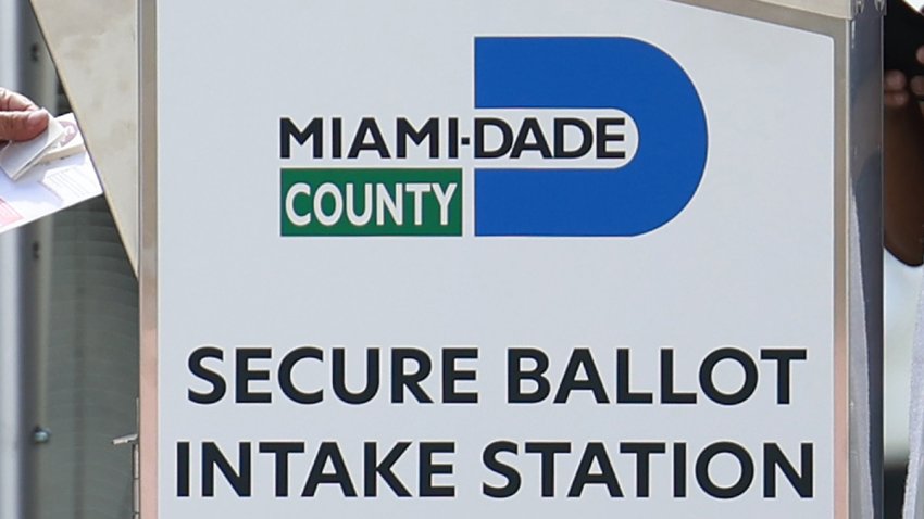 MIAMI, FLORIDA – OCTOBER 31: An official at the Miami-Dade County Elections Department places a voters ballot in a secure ballot intake station before the November 8th general election on October 31, 2022 in Miami, Florida. Voters will decide who will win a Florida Senate seat and also be the next Florida Governor, among other races. (Photo by Joe Raedle/Getty Images)