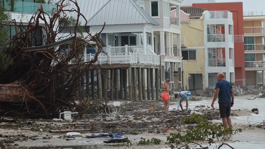 TREASURE ISLAND, FLORIDA – SEPTEMBER 28: Trees and debris lay on the beach as people walk after Hurricane Helene hit the area with high surge waters as it passed offshore on September 28, 2024 in Treasure Island, Florida. Hurricane Helene made landfall Thursday night in Florida’s Big Bend with winds up to 140 mph and storm surges that killed at least 42 people in several states. (Photo by Joe Raedle/Getty Images)