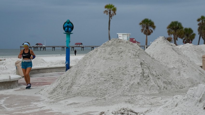 A woman jogs along piles of sand cleared from the street as a result of Hurricane Helene in Clearwater, Florida ahead of Hurricane Milton’s expected mid-week landfall, on October 6, 2024. Another potentially devastating storm barreled toward the Florida coast on October 6, as the head of the US disaster relief agency lashed out at a “dangerous” misinformation war being waged over the aftermath of Hurricane Helene.
The National Hurricane Center (NHC) said the new storm, Milton, had intensified into a Category 1 hurricane Sunday with maximum sustained winds of 80 miles (130 kilometers) an hour. (Photo by Bryan R. SMITH / AFP) (Photo by BRYAN R. SMITH/AFP via Getty Images)