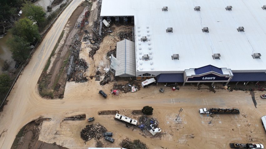 ASHEVILLE, NORTH CAROLINA – OCTOBER 03: In an aerial view, flood damage is seen at a Lowe’s wrought by Hurricane Helene along the Swannanoa River on October 3, 2024 in Asheville, North Carolina. At least 200 people were killed in six states in the wake of the powerful hurricane which made landfall as a Category 4. President Joe Biden took an aerial tour of the devastated region yesterday and ordered the deployment of 1,000 active duty U.S. soldiers to assist with storm relief efforts and reinforce the North Carolina National Guard.  (Photo by Mario Tama/Getty Images)