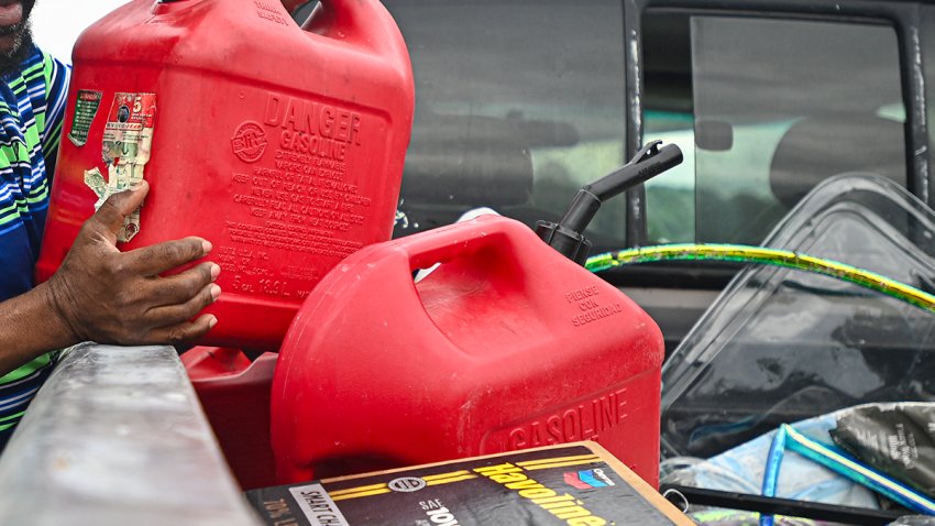 People fill up gas containers at a station ahead of Hurricane Milton’s expected landfall in Lakeland, Florida on October 8, 2024. Storm-battered Florida girded Tuesday for a direct hit from Hurricane Milton, a monster weather system threatening catastrophic damage and forcing President Joe Biden to postpone a major overseas trip. (Photo by Miguel J. Rodriguez Carrillo / AFP) (Photo by MIGUEL J. RODRIGUEZ CARRILLO/AFP via Getty Images)