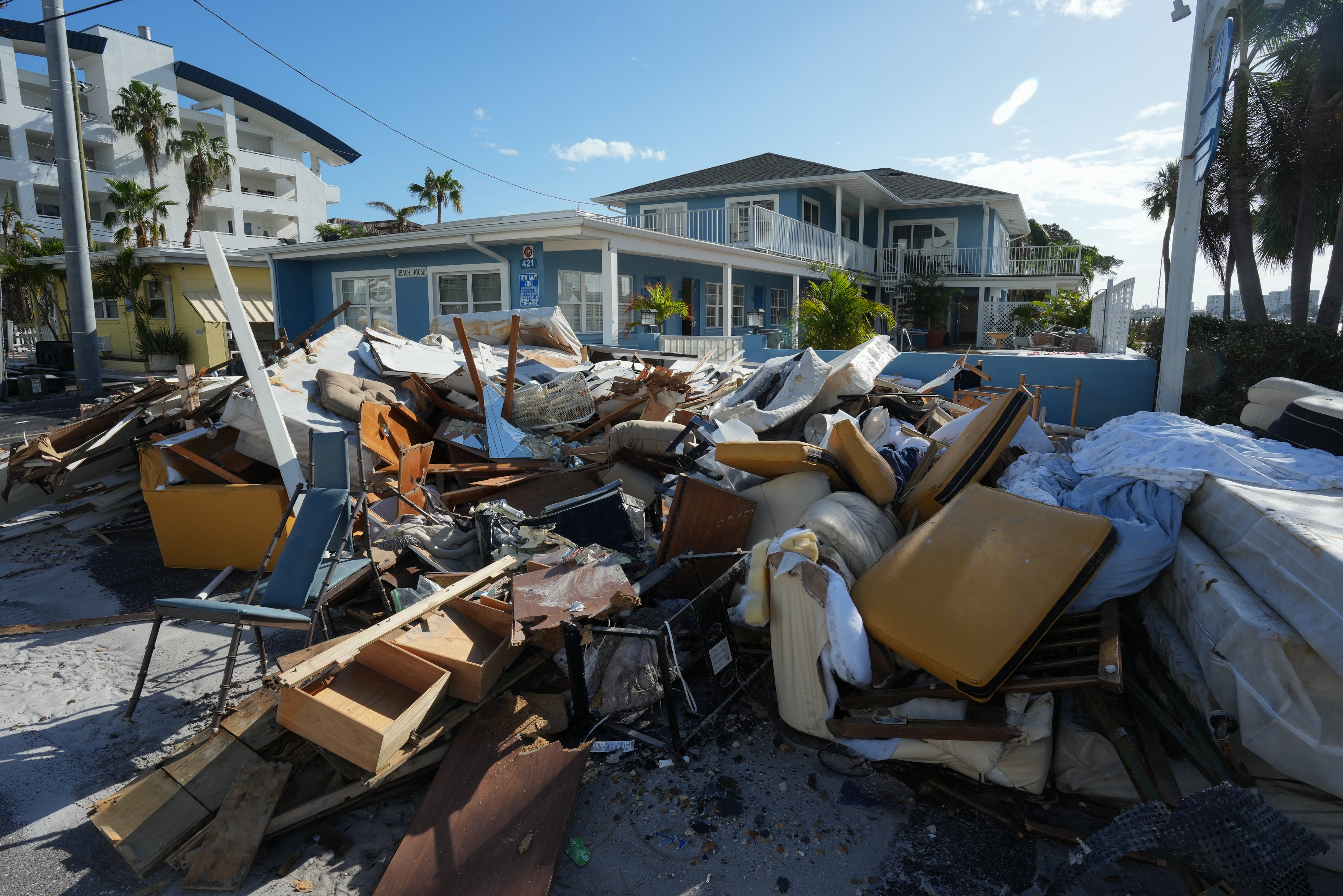 Debris lines a street in Clearwater Beach, Fla, on Oct. 11, 2024.