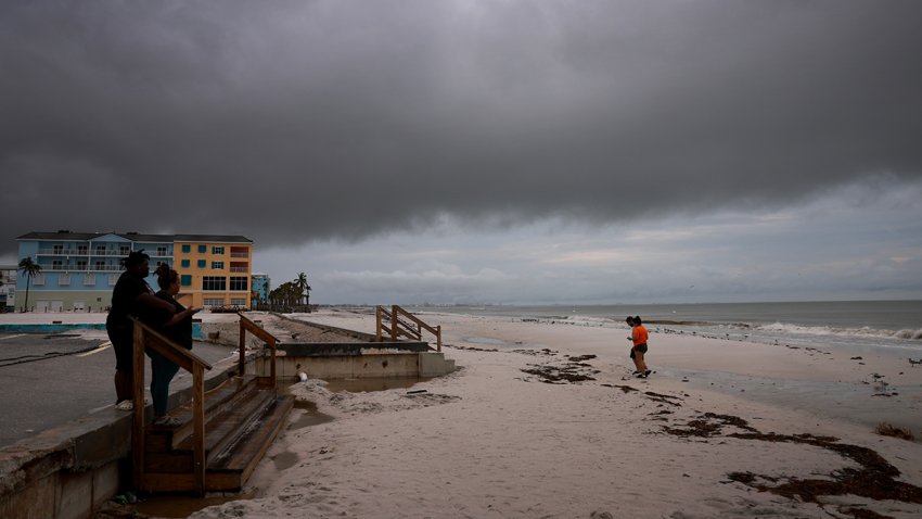 FORT MYERS, FLORIDA – OCTOBER 08: People visit the beach as storm clouds hang pass overhead before Hurricane Milton’s arrival on October 08, 2024 in Fort Myers, Florida. People are preparing for the storm, which could be a Cat 3 when it makes landfall on Wednesday evening. (Photo by Joe Raedle/Getty Images)