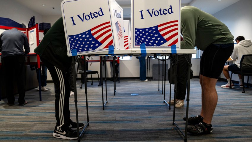 Voters mark their ballots during early voting at a polling location at the Ellen M. Bozeman Government Center in Arlington, Virginia, US, on Saturday, Oct. 26, 2024. A federal judge in Virginia on Friday halted what she concluded was an unlawful, systematic purge of names from the state’s voter rolls ahead of the Nov. 5 presidential election, in a win for the Biden administration. Photographer: Kent Nishimura/Bloomberg via Getty Images