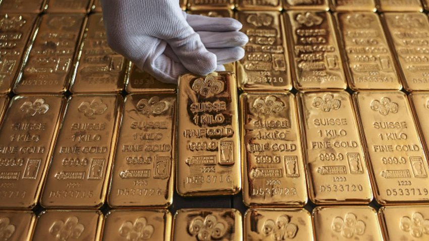 An employee handles one kilogram gold bullions at the YLG Bullion International Co. headquarters in Bangkok, Thailand, on Friday, Dec. 22, 2023. 