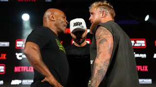 (L-R) Mike Tyson, Nakisa Bidarian and Jake Paul pose onstage during the Jake Paul vs. Mike Tyson Boxing match press conference at Texas Live! in Arlington, Texas, on May 16, 2024.