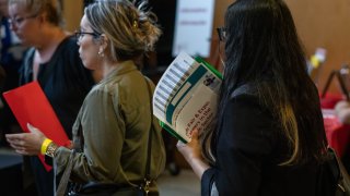A jobseeker holds flyers during the New York Public Library’s annual Bronx Job Fair & Expo at the the Bronx Library Center in the Bronx borough of New York, US, on Friday, Sept. 6, 2024.
